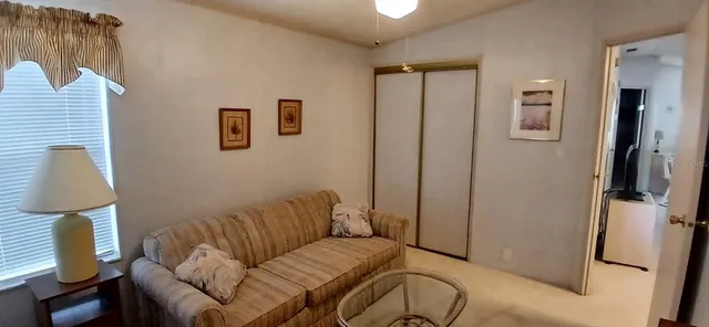 a living room with furniture gym equipment and a large window