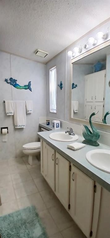 278 Pine Loop Frostproof, FL 33843 - Photo 36 of 40 a bathroom with a double vanity sink and a toilet
