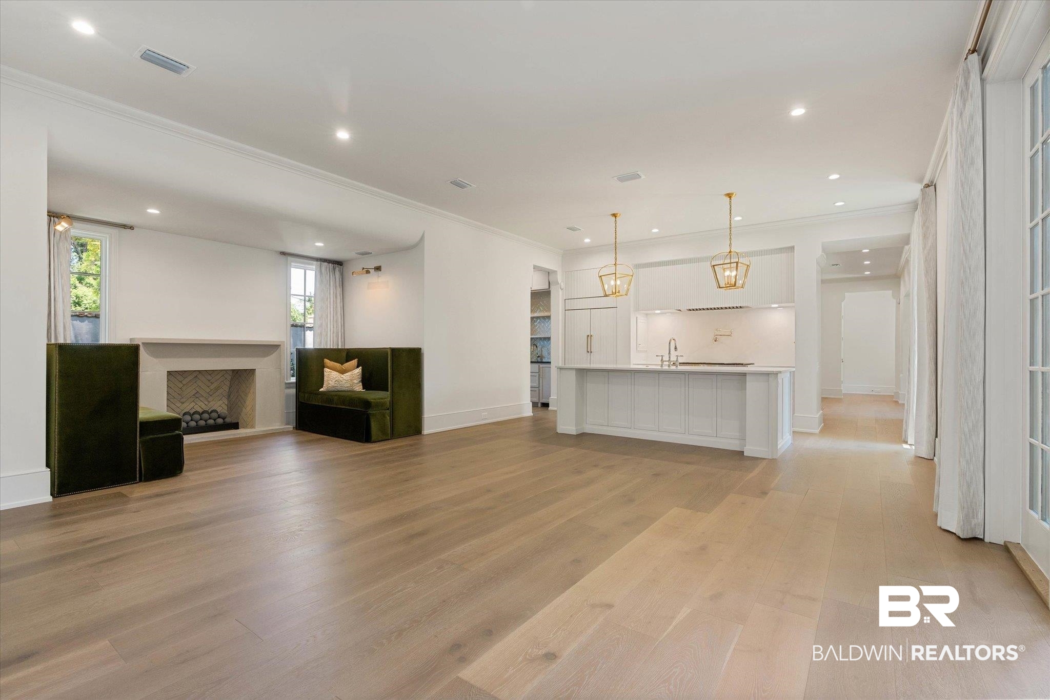 3 Canterbury Park Mobile, AL 36608 - Photo 10 of 43 Unfurnished living room featuring a fireplace, light wood-style floors, crown molding, recessed lighting, and baseboards