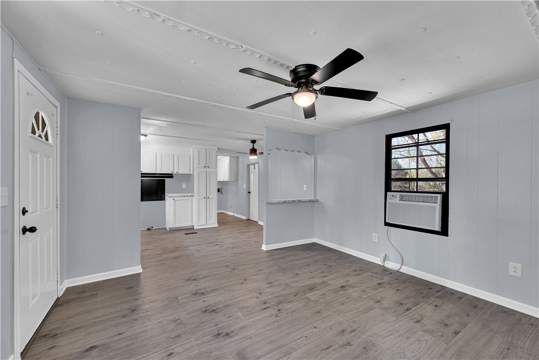 Bright and airy open concept living area with durable flooring flows seamlessly into the kitchen.