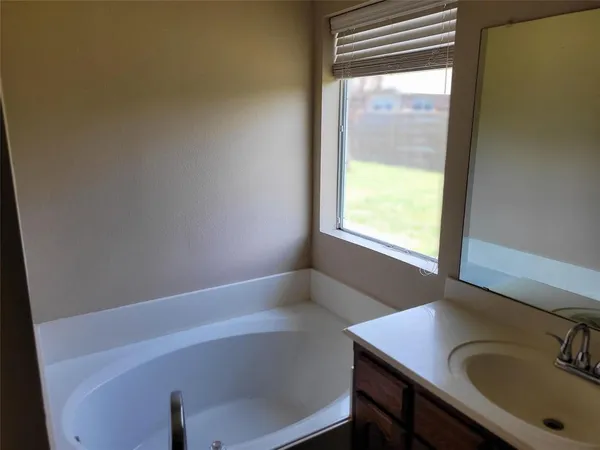 a bathroom with a sink and a window