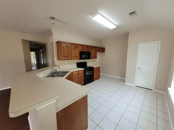 a kitchen with stainless steel appliances a refrigerator and a stove top oven