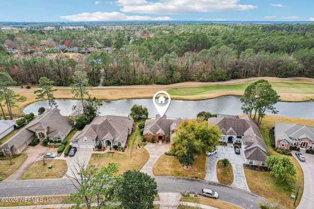 a dining room with wooden floor a chandelier a wooden table and chairs
