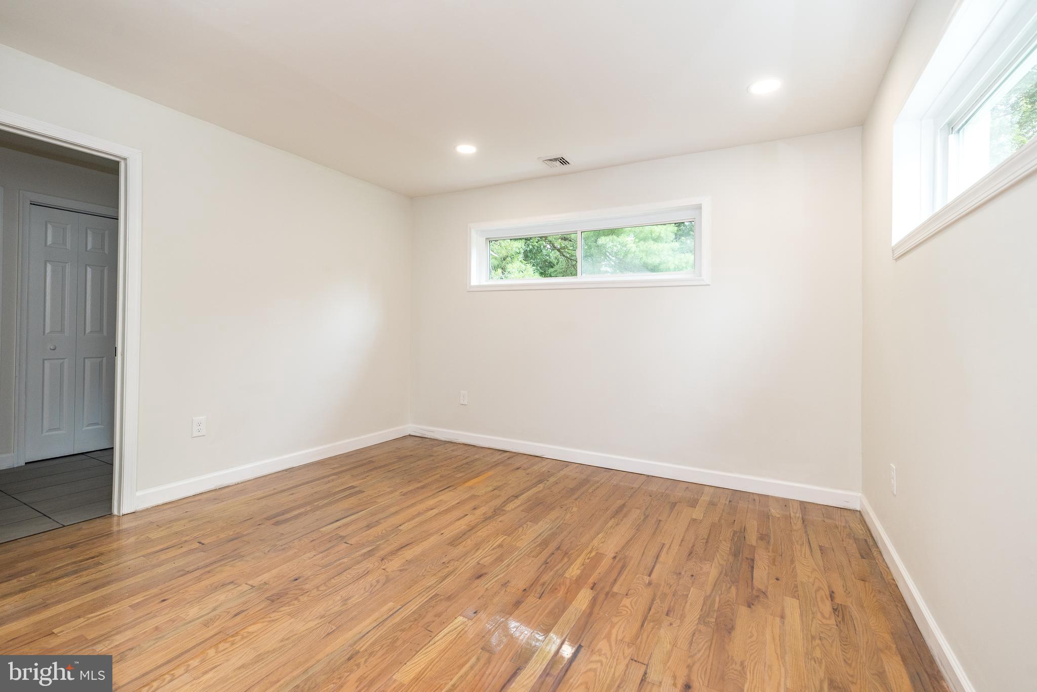 219 Stony Run Road Spring City, PA 19475 - Photo 17 of 35 an empty room with wooden floor and windows