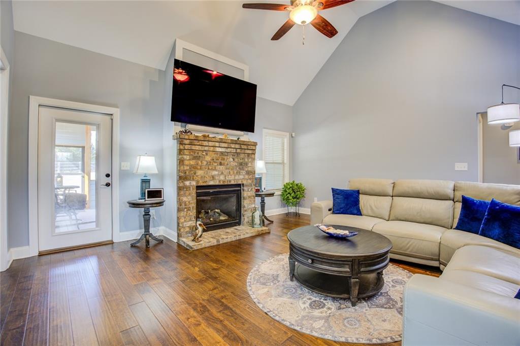1021 Arbor Court Madison, GA 30650 - Photo 12 of 64 a living room with furniture a flat screen tv and a fireplace