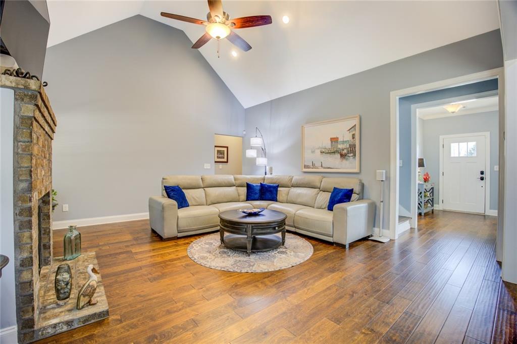 1021 Arbor Court Madison, GA 30650 - Photo 13 of 64 a living room with furniture and a wooden floor