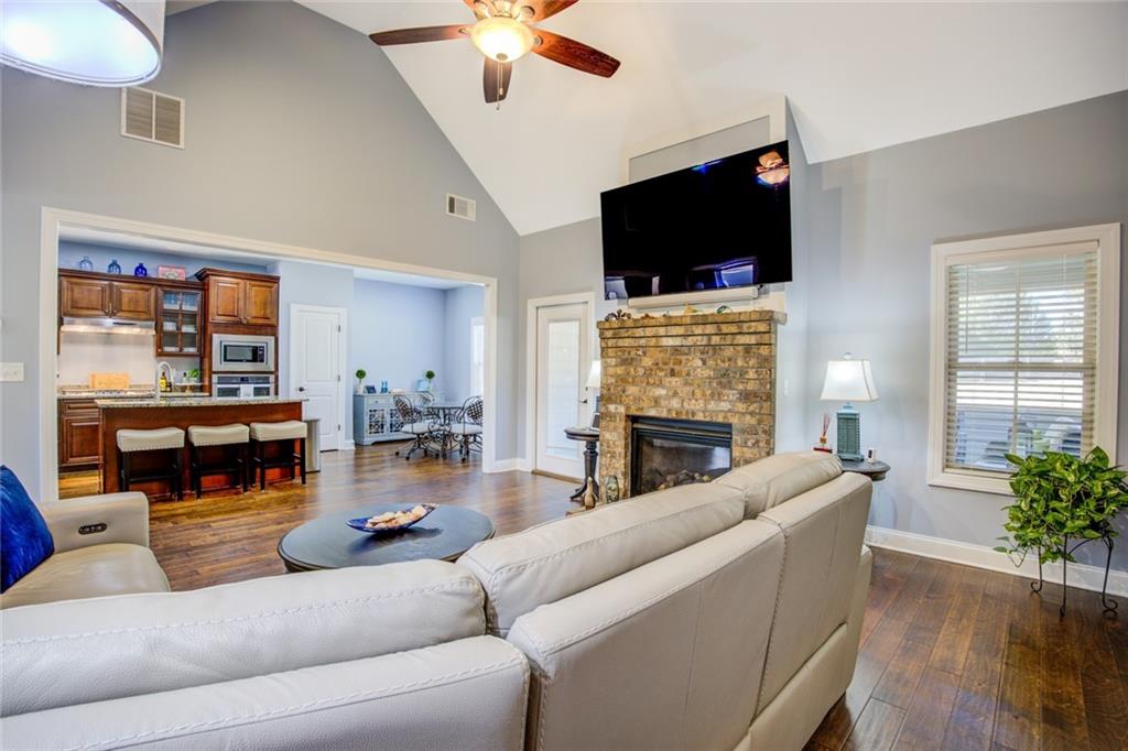 1021 Arbor Court Madison, GA 30650 - Photo 15 of 64 a living room with furniture a flat screen tv and a fireplace