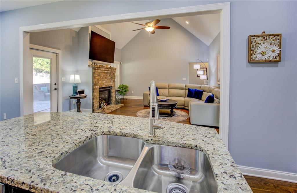 1021 Arbor Court Madison, GA 30650 - Photo 20 of 64 a kitchen with granite countertop a sink and a refrigerator