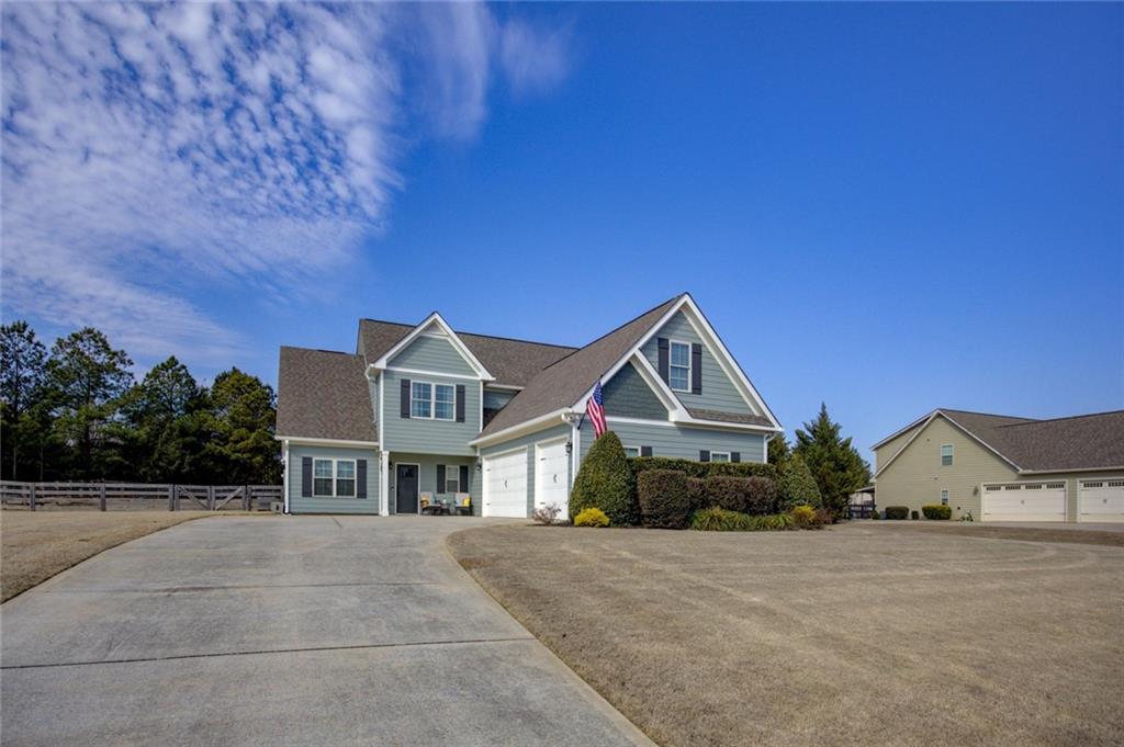 1021 Arbor Court Madison, GA 30650 - Photo 2 of 64 a front view of a house with a yard