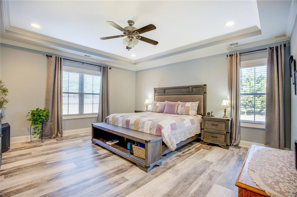 1021 Arbor Court Madison, GA 30650 - Photo 26 of 64 a bedroom with a bed a dresser next to a window