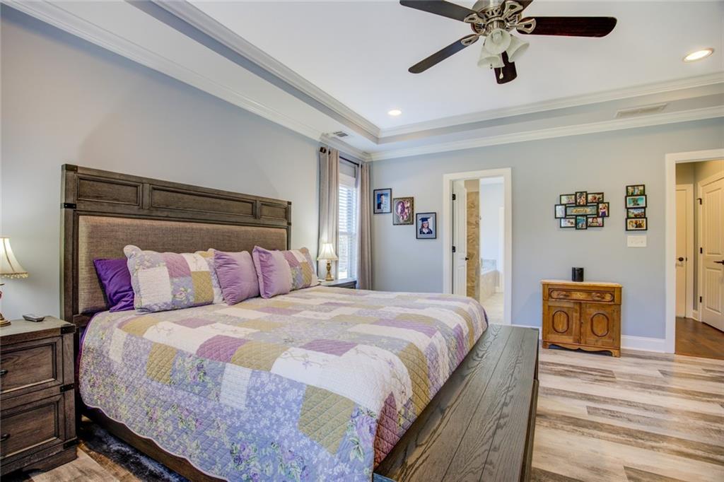 1021 Arbor Court Madison, GA 30650 - Photo 27 of 64 a bedroom with a bed and a chandelier
