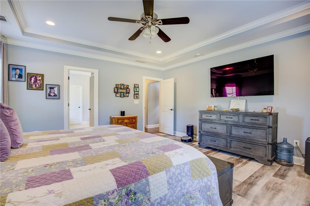 1021 Arbor Court Madison, GA 30650 - Photo 28 of 64 a bedroom with a bed and a flat screen tv