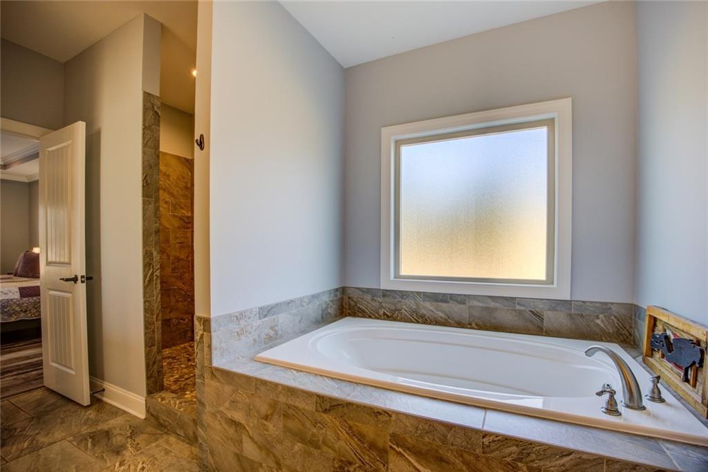 1021 Arbor Court Madison, GA 30650 - Photo 31 of 64 a bathroom with a bathtub and a shower