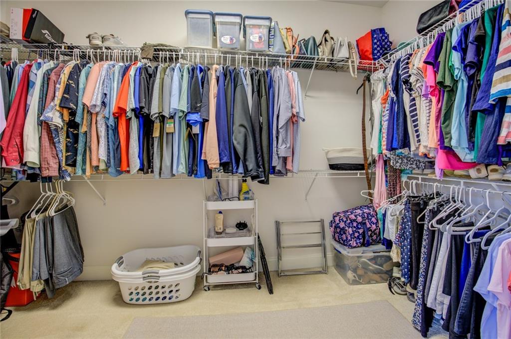 1021 Arbor Court Madison, GA 30650 - Photo 35 of 64 a view of walk in closet with clothes and shoes