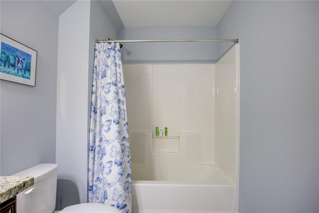 1021 Arbor Court Madison, GA 30650 - Photo 45 of 64 a bathroom with a shower curtain and toilet