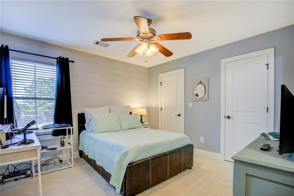 1021 Arbor Court Madison, GA 30650 - Photo 47 of 64 a bedroom with a bed and a flat screen tv