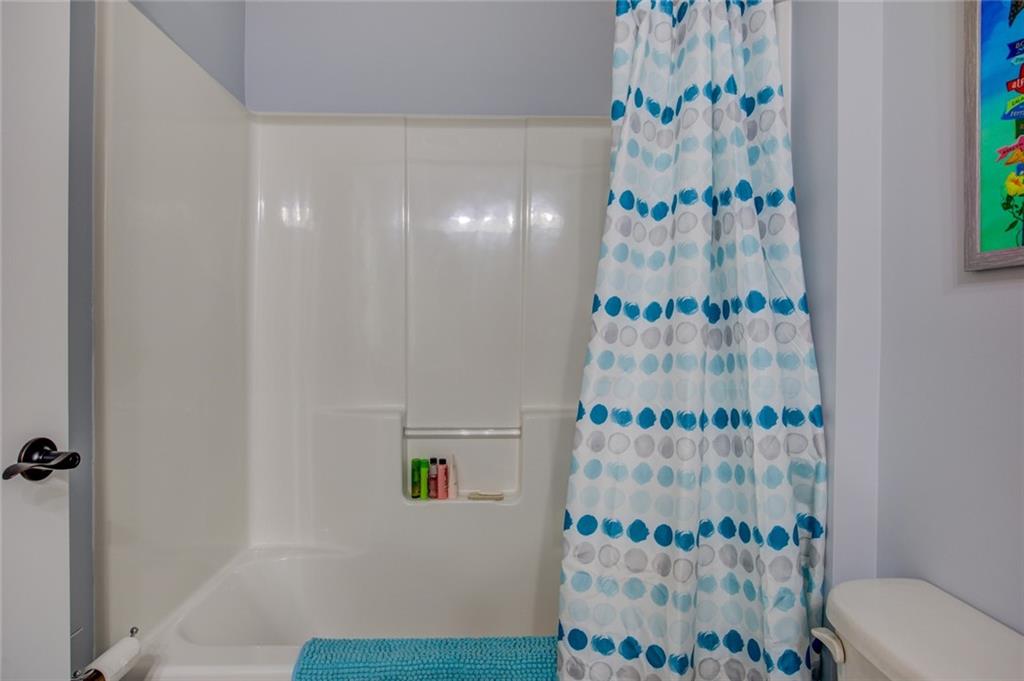 1021 Arbor Court Madison, GA 30650 - Photo 51 of 64 a bathroom with a shower curtain and a table