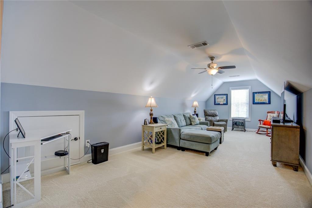 1021 Arbor Court Madison, GA 30650 - Photo 54 of 64 a living room with furniture and a chandelier