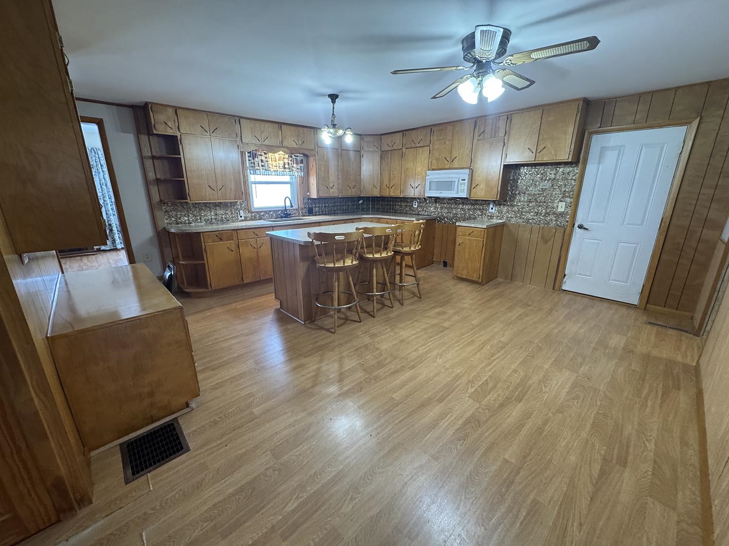 18341 Pleasant Hill Road Mount Carroll, IL 61053 - Photo 20 of 41 a kitchen with stainless steel appliances kitchen island granite countertop wooden floors and a sink