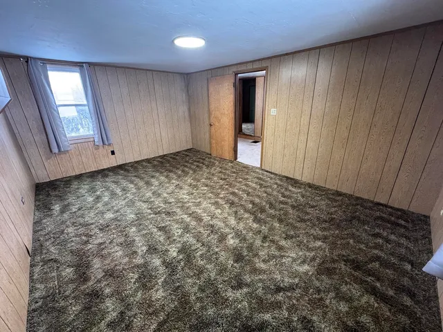a view of a closet area with wooden floor
