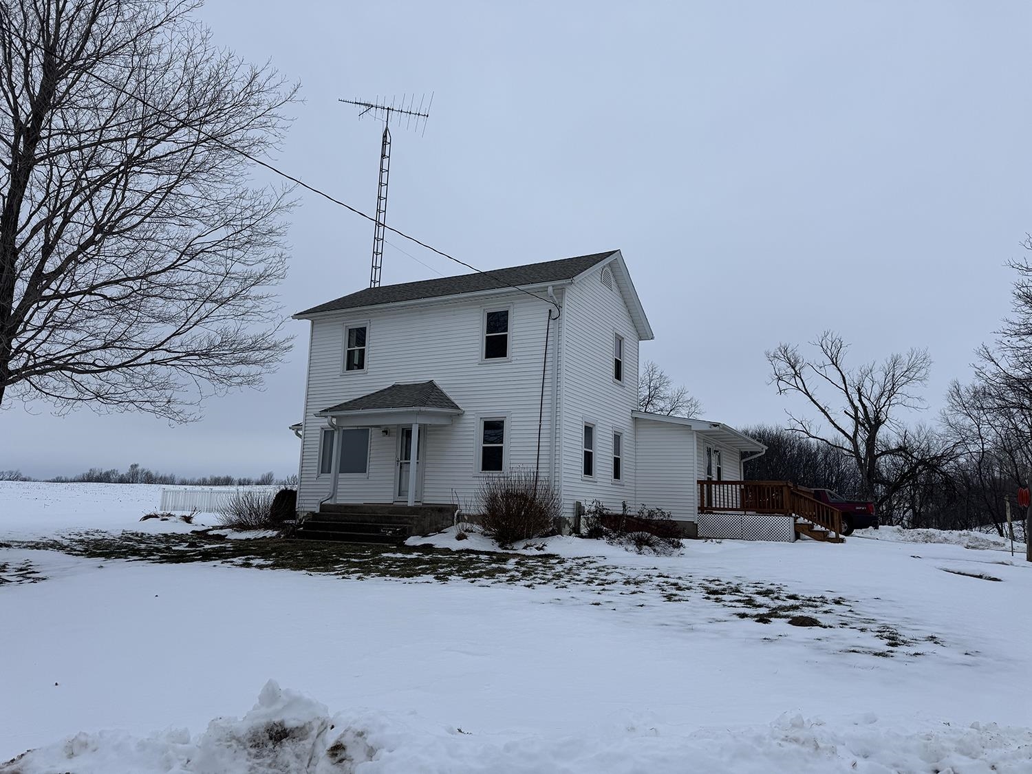 18341 Pleasant Hill Road Mount Carroll, IL 61053 - Photo 3 of 41 a front view of a house with a yard covered in snow