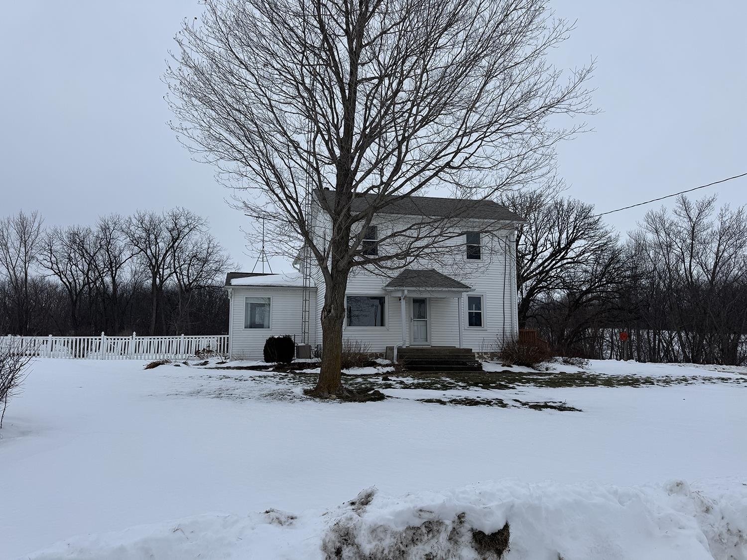 18341 Pleasant Hill Road Mount Carroll, IL 61053 - Photo 4 of 41 a front view of a house with a yard covered in snow