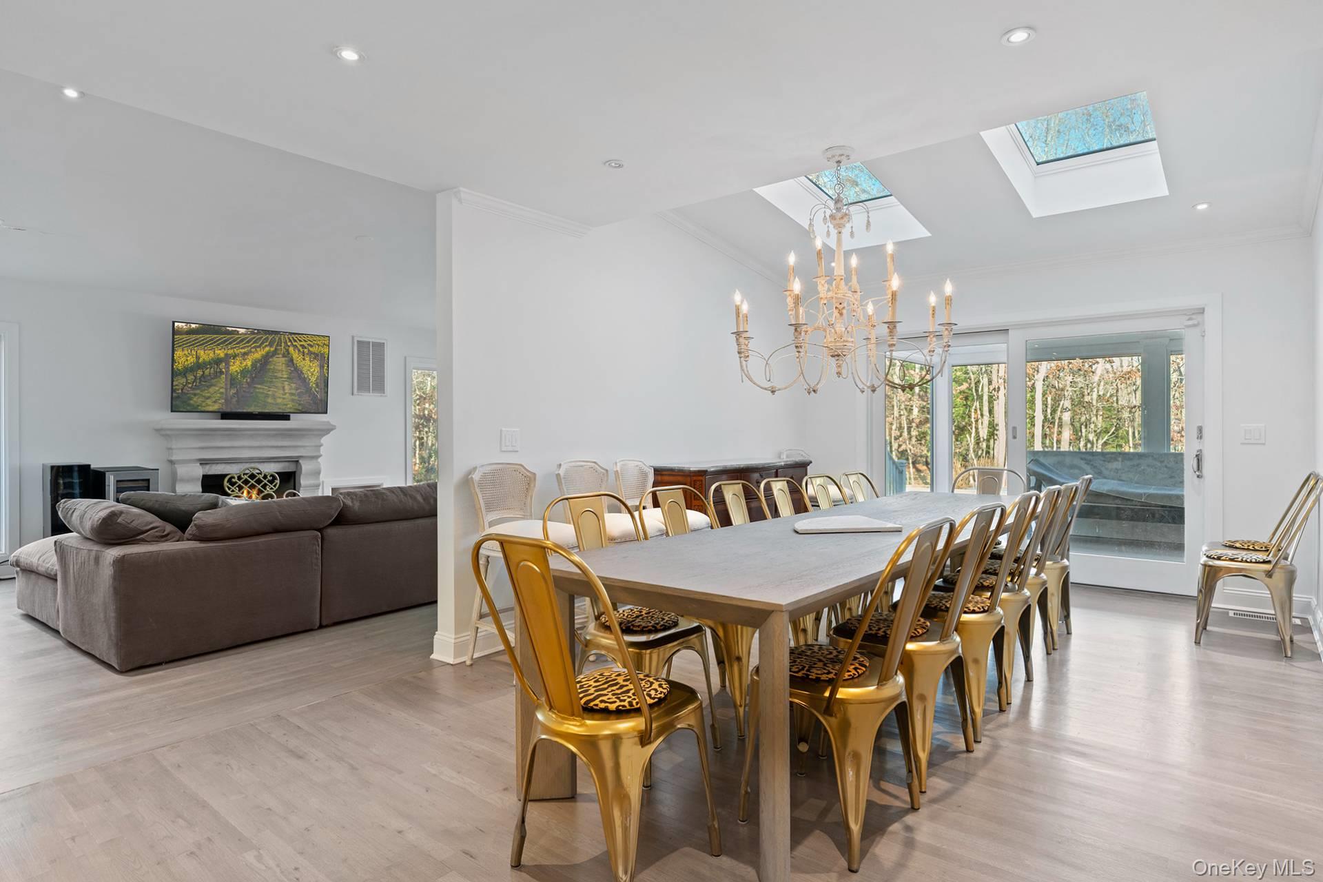 1824 Majors Path Southampton, NY 11968 - Photo 12 of 28 a view of a dining room with furniture a chandelier and wooden floor