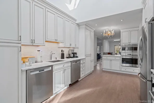 a kitchen with stainless steel appliances granite countertop a refrigerator sink and cabinets