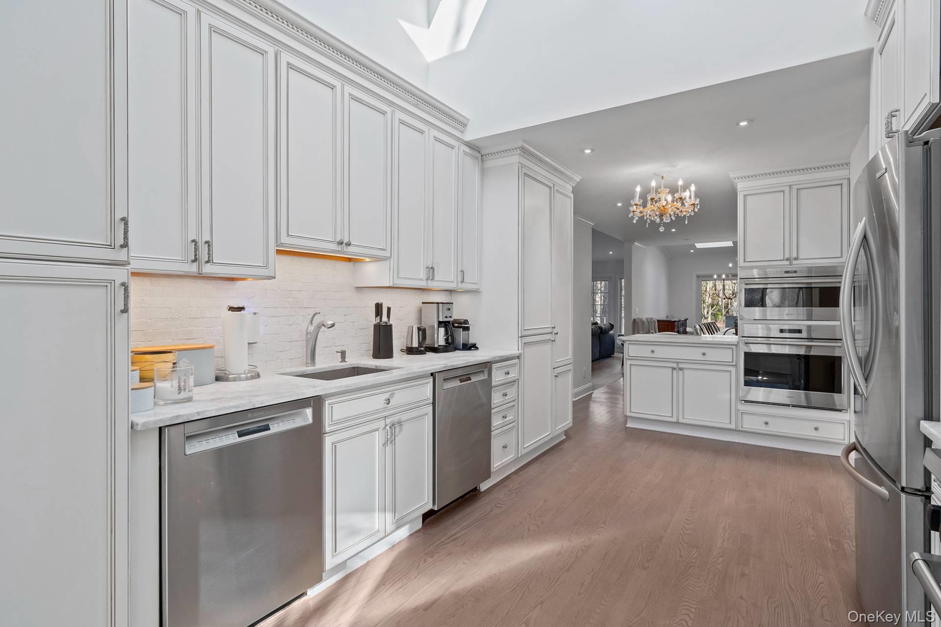 1824 Majors Path Southampton, NY 11968 - Photo 15 of 28 a kitchen with stainless steel appliances granite countertop a refrigerator sink and cabinets