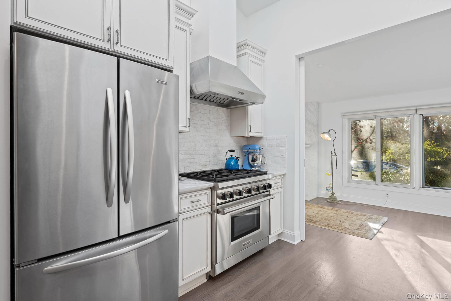 1824 Majors Path Southampton, NY 11968 - Photo 16 of 28 a kitchen with stainless steel appliances a stove a refrigerator and a window