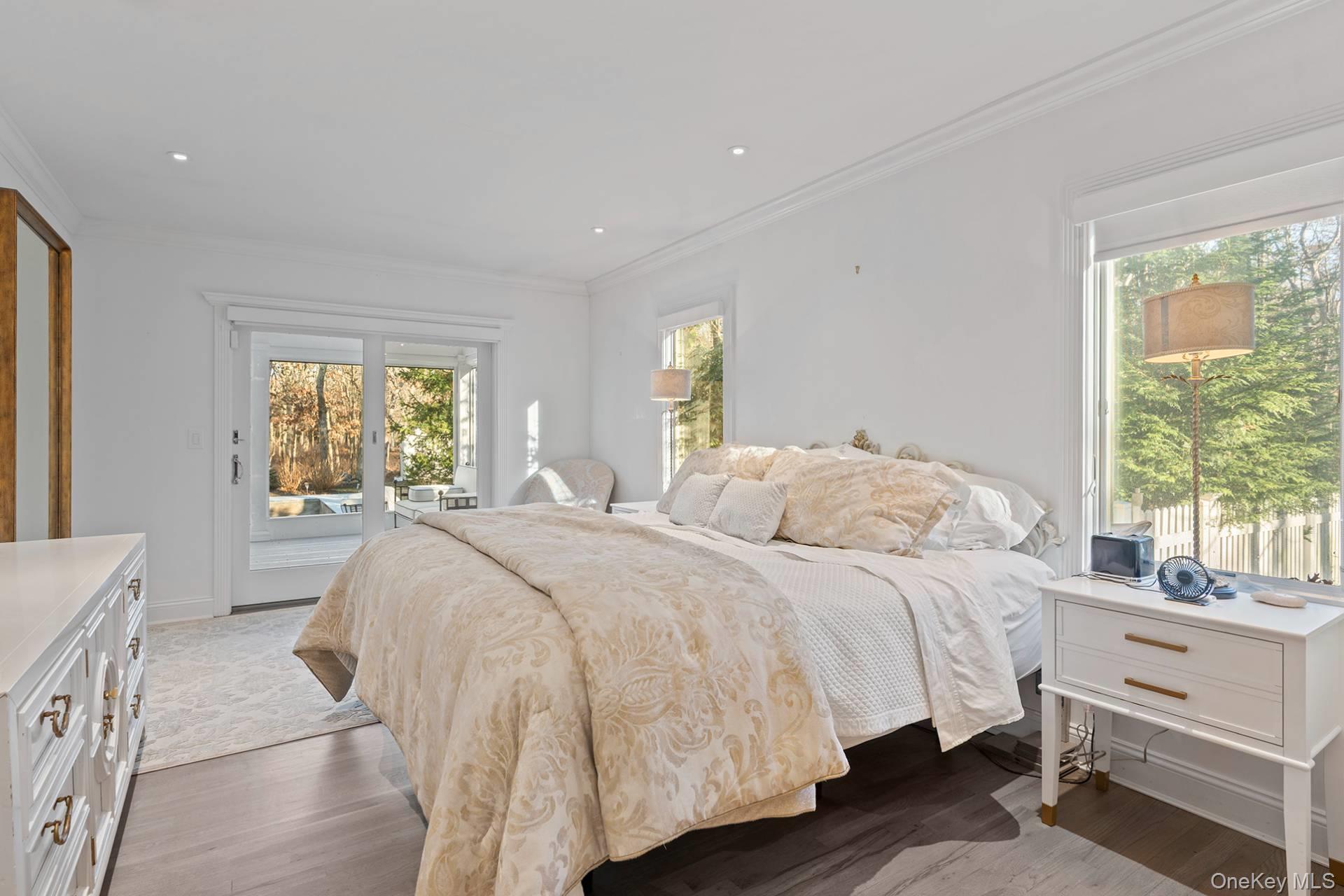 1824 Majors Path Southampton, NY 11968 - Photo 18 of 28 Bedroom with access to outside, multiple windows, wood finished floors, crown molding, and recessed lighting