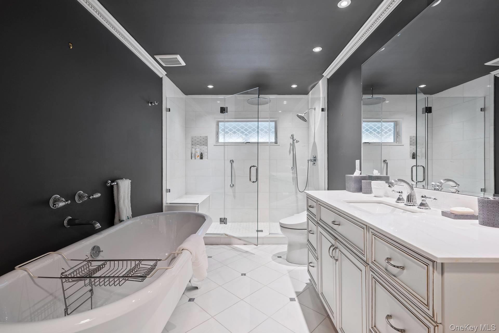 1824 Majors Path Southampton, NY 11968 - Photo 20 of 28 Bathroom with vanity, a soaking tub, crown molding, a stall shower, and healthy amount of natural light