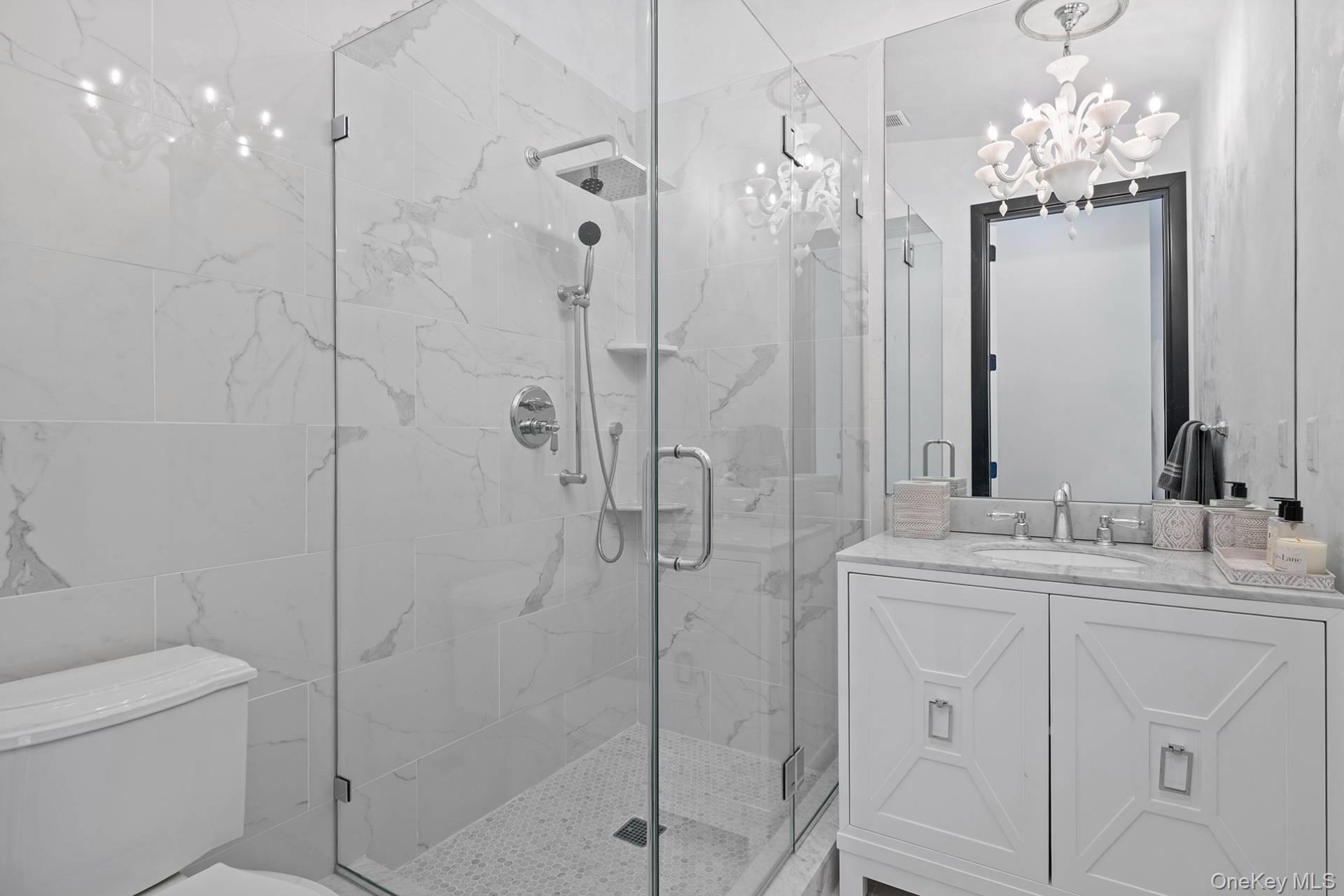 1824 Majors Path Southampton, NY 11968 - Photo 22 of 28 Bathroom with vanity, a marble finish shower, and a chandelier