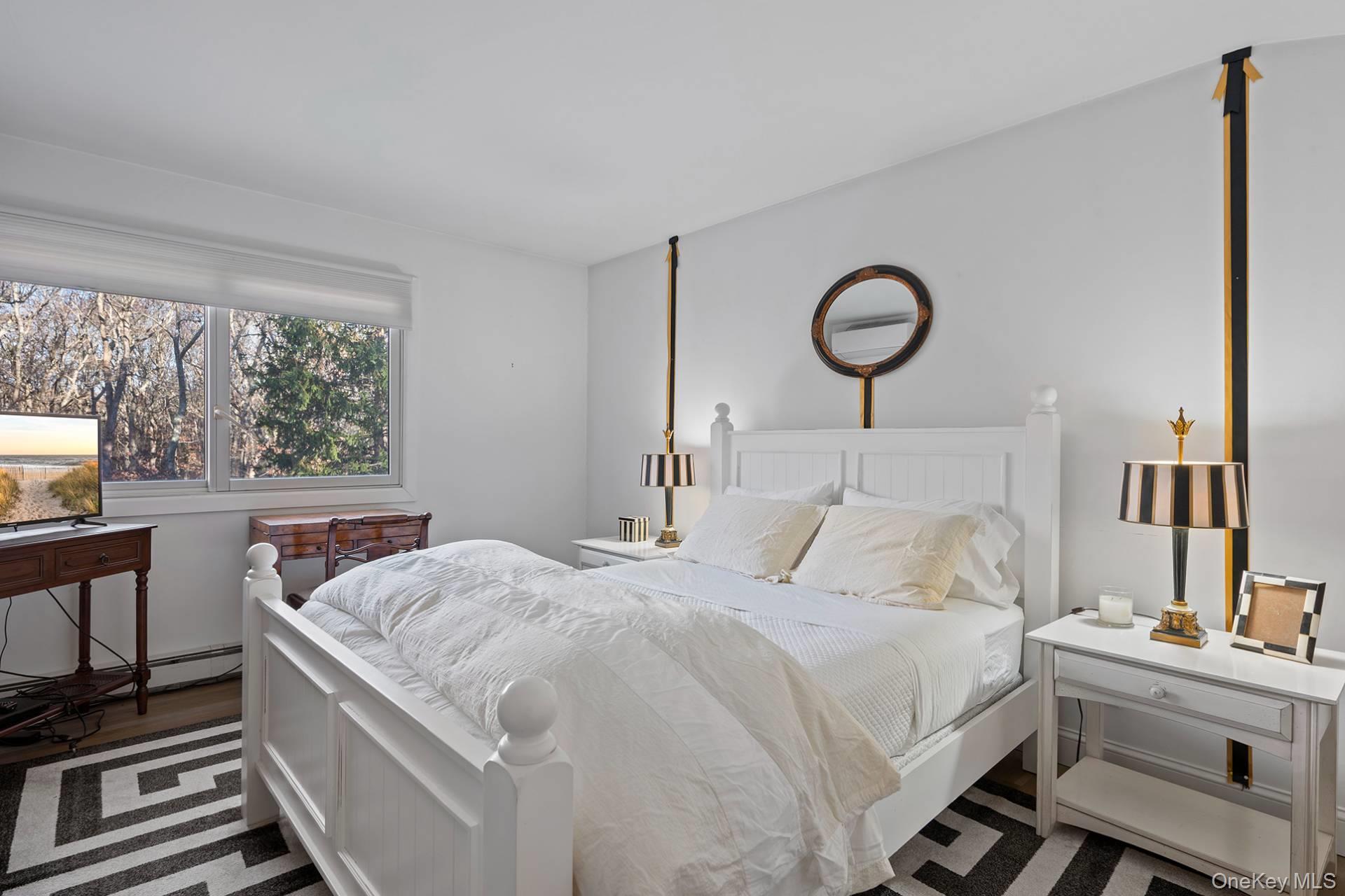 1824 Majors Path Southampton, NY 11968 - Photo 22 of 28 a bedroom with a bed and a flat screen tv on the dresser