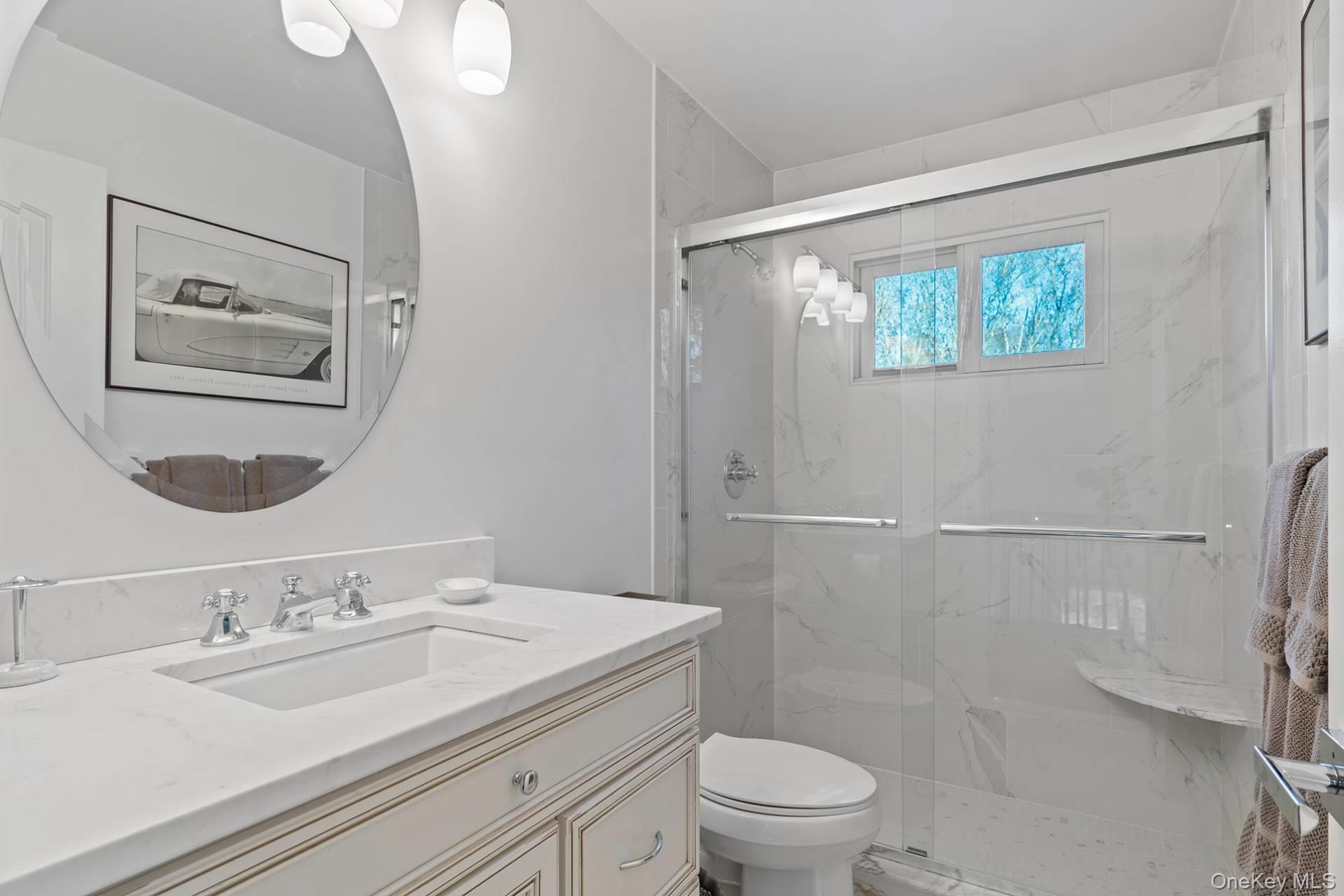 1824 Majors Path Southampton, NY 11968 - Photo 24 of 28 a bathroom with a granite countertop sink mirror vanity and toilet