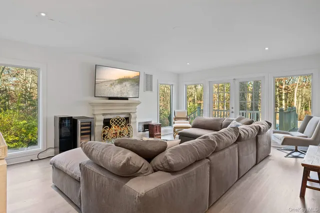 a living room with fireplace furniture and a large window