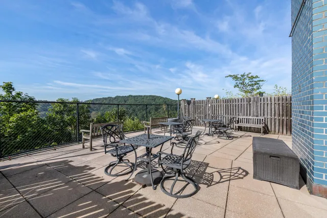 a view of a balcony with two chairs and a table