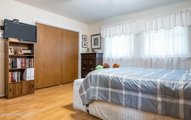 a bedroom with a bed and a book shelf