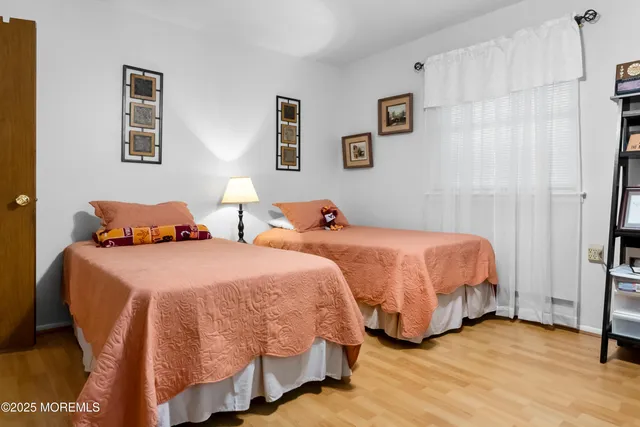 a bedroom with two beds and a lamp