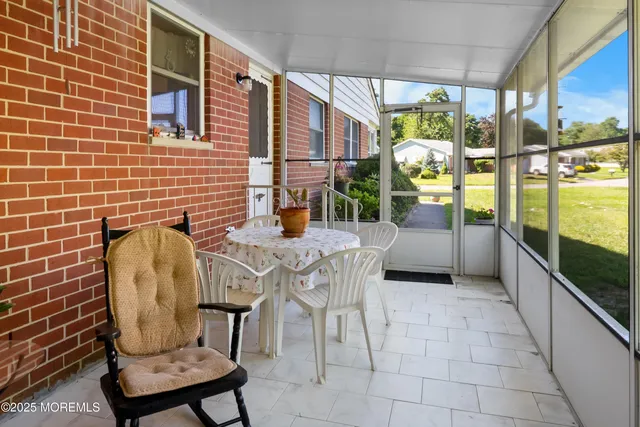 a view of a chairs and table in the balcony