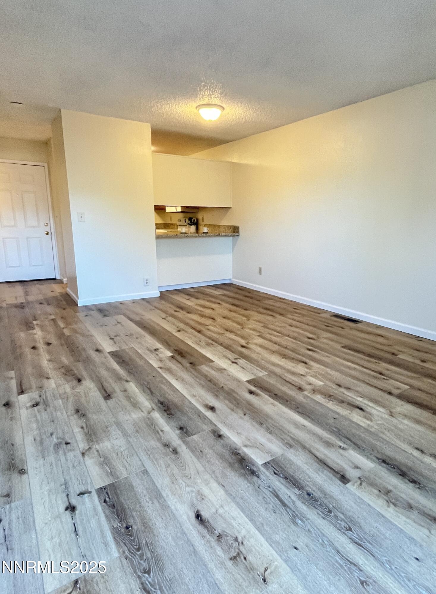 4985 West 7th Street, Unit 16 Reno, NV 89503 - Photo 3 of 10 a view of a room with wooden floor