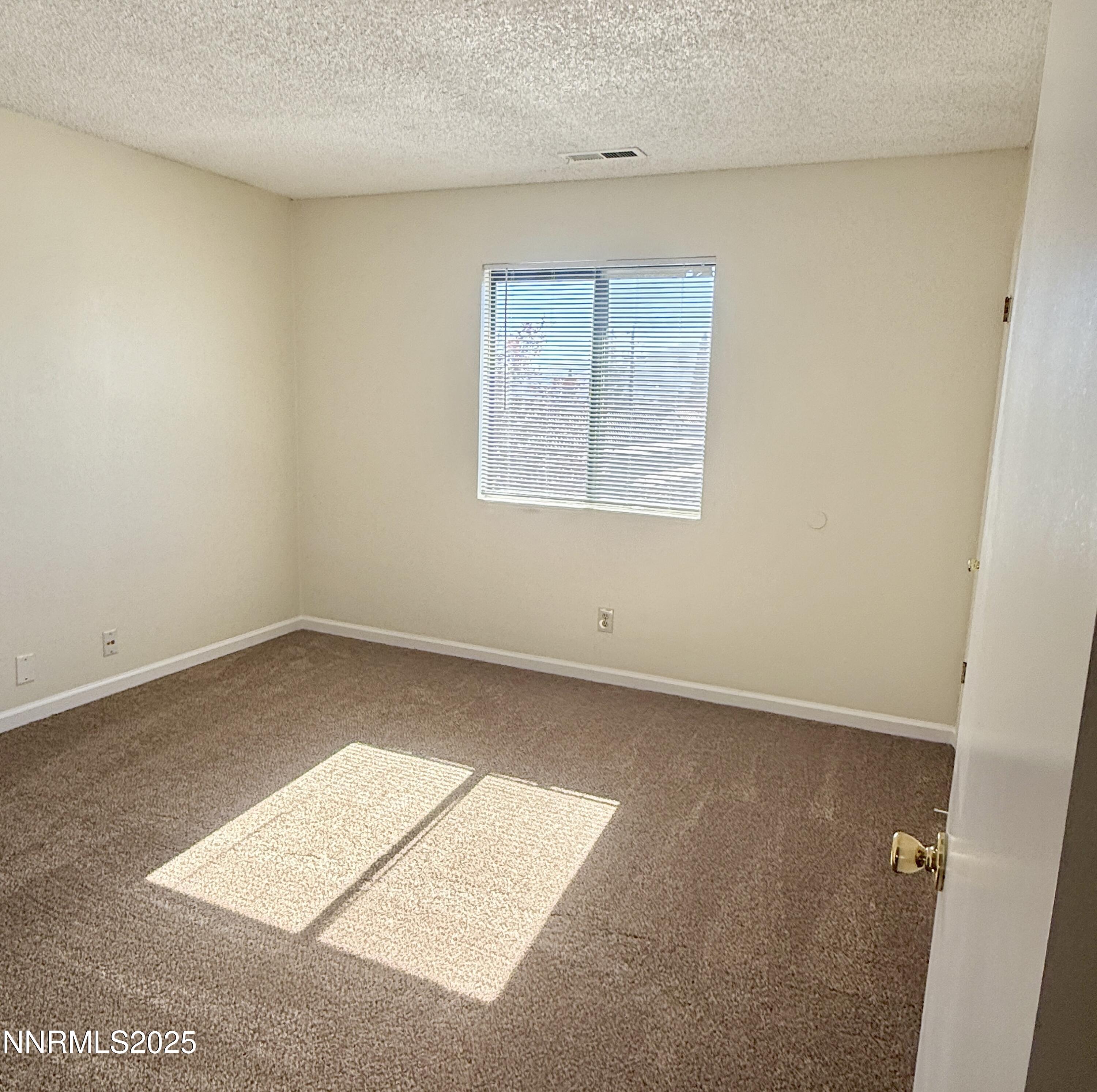 4985 West 7th Street, Unit 16 Reno, NV 89503 - Photo 7 of 10 an empty room with windows