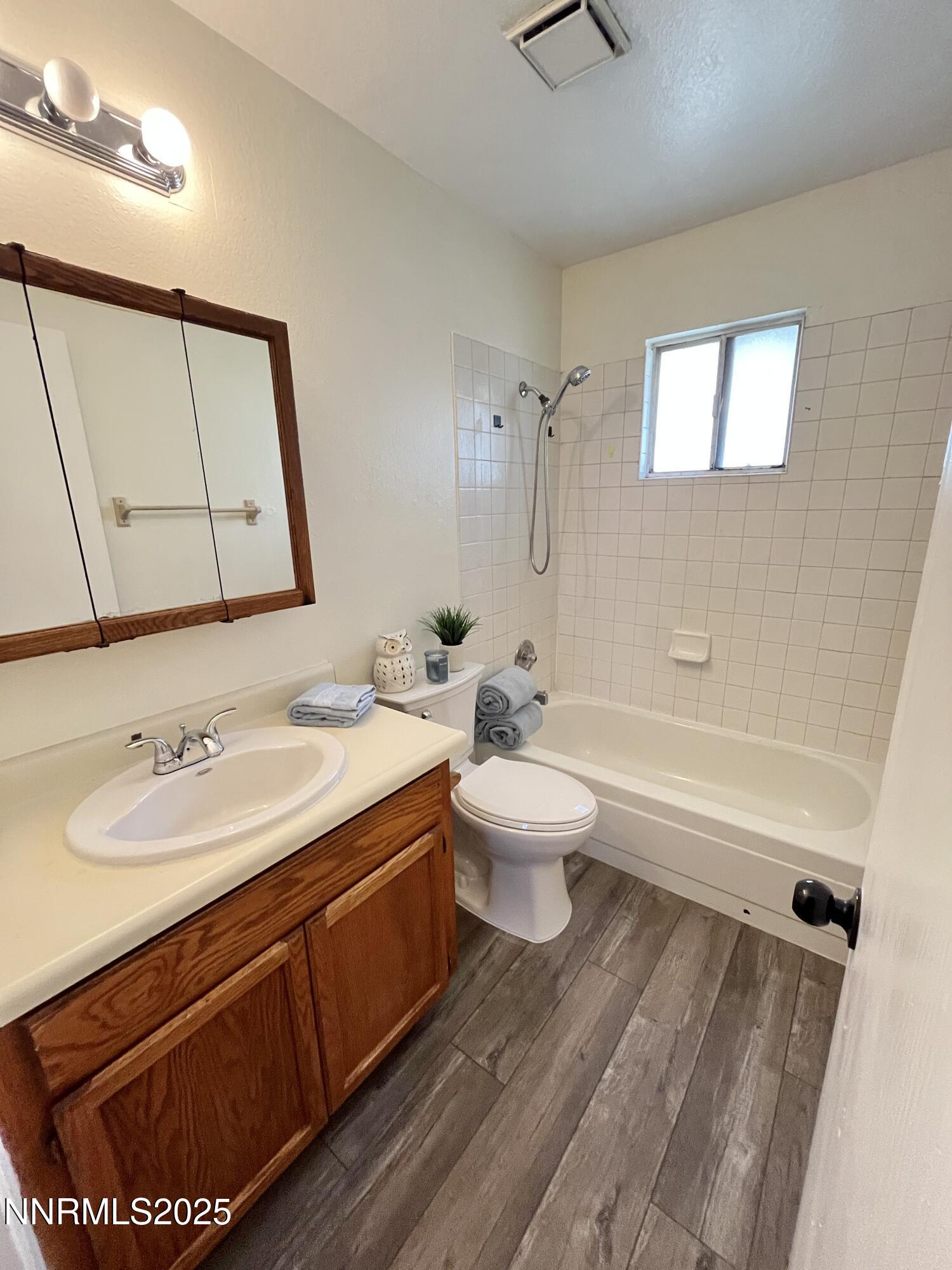 4985 West 7th Street, Unit 16 Reno, NV 89503 - Photo 8 of 10 a bathroom with a sink a toilet and bathtub