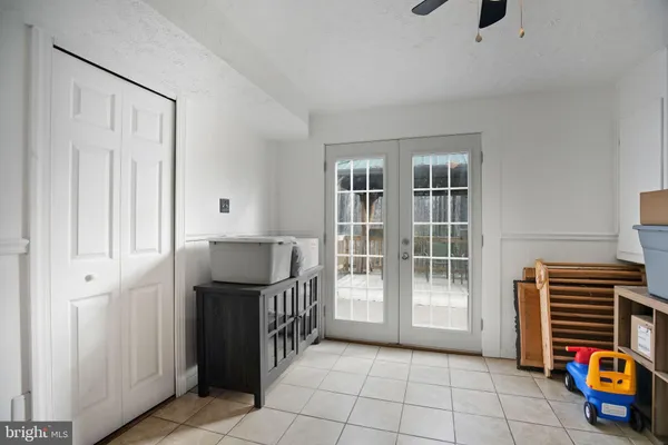 a view of an empty room with fridge and workspace