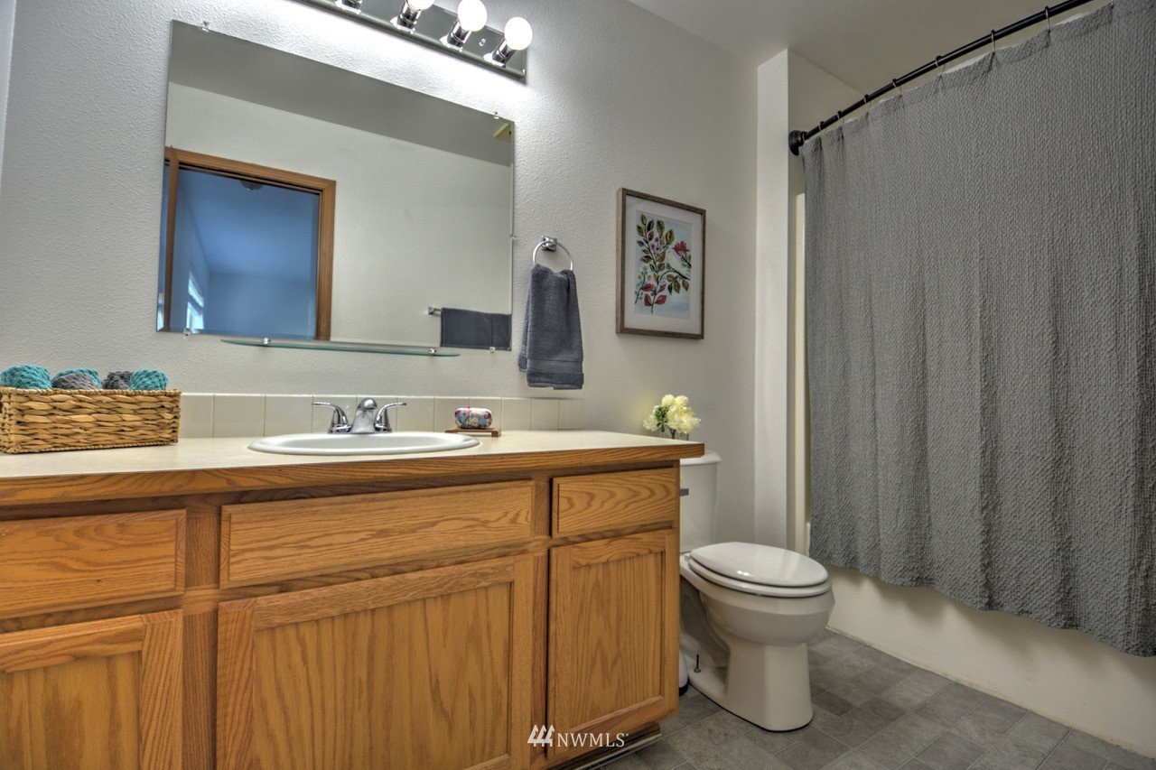 1308 Golf Club Road Southeast Lacey, WA 98503 - Photo 14 of 23 a bathroom with a sink a toilet and shower