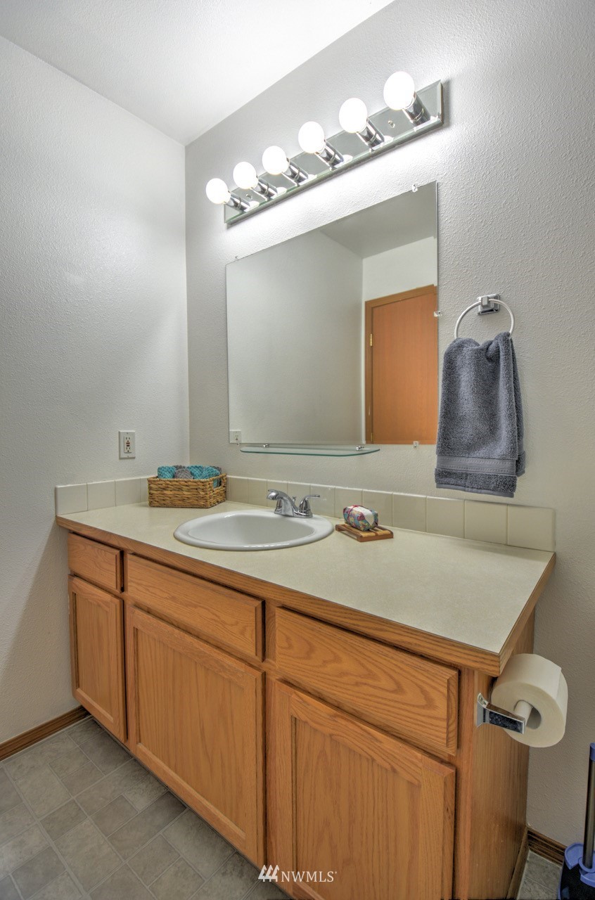 1308 Golf Club Road Southeast Lacey, WA 98503 - Photo 15 of 23 a bathroom with a sink and a mirror