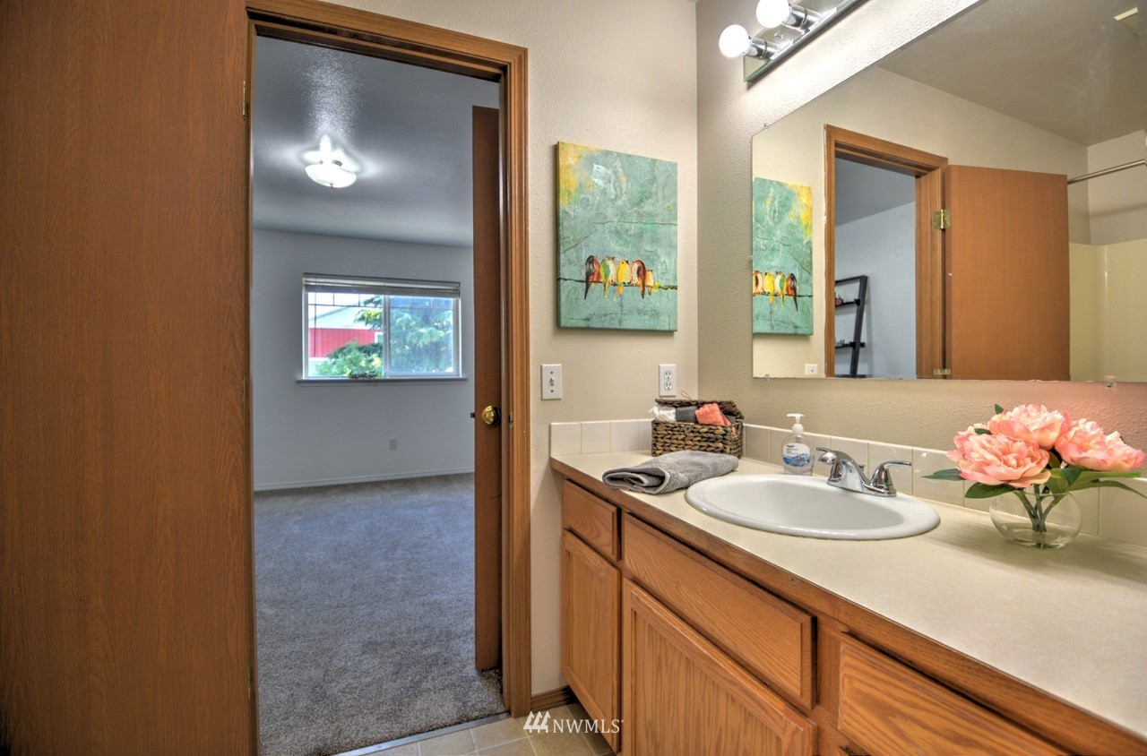 1308 Golf Club Road Southeast Lacey, WA 98503 - Photo 18 of 23 a bathroom with a sink and a mirror