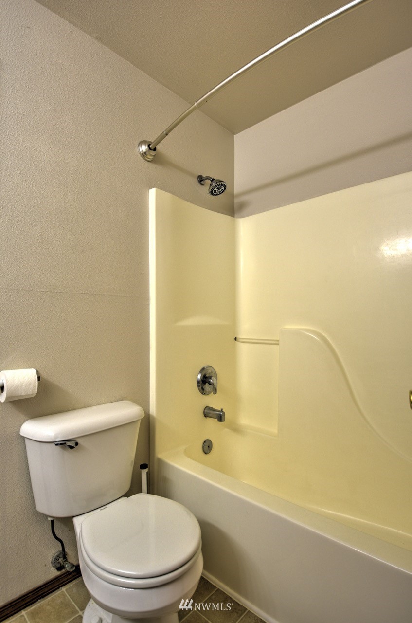 1308 Golf Club Road Southeast Lacey, WA 98503 - Photo 19 of 23 a white toilet sitting next to a bath tub and a shower