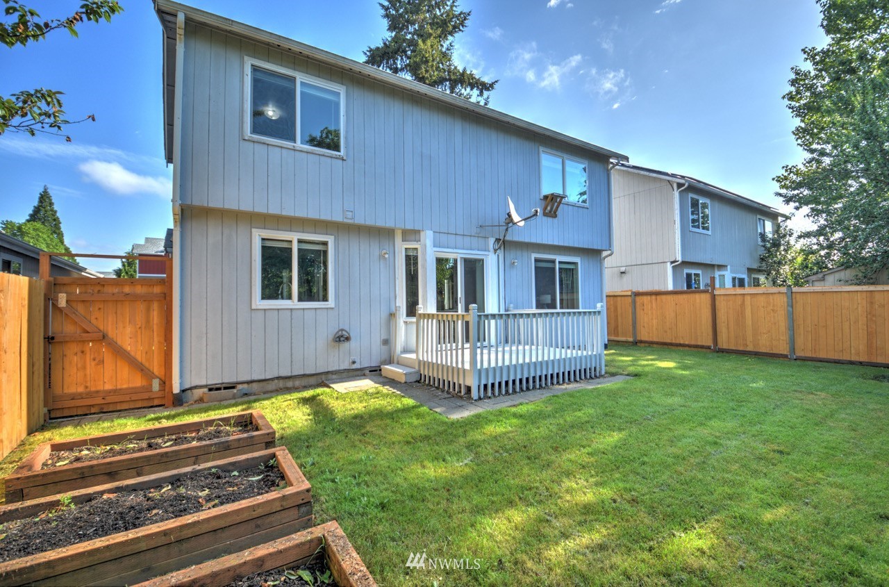 1308 Golf Club Road Southeast Lacey, WA 98503 - Photo 23 of 23 a backyard of a house with a garden and barbeque oven