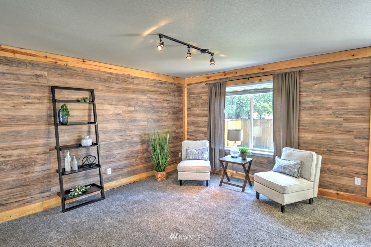 1308 Golf Club Road Southeast Lacey, WA 98503 - Photo 3 of 23 a living room with furniture and a floor to ceiling window